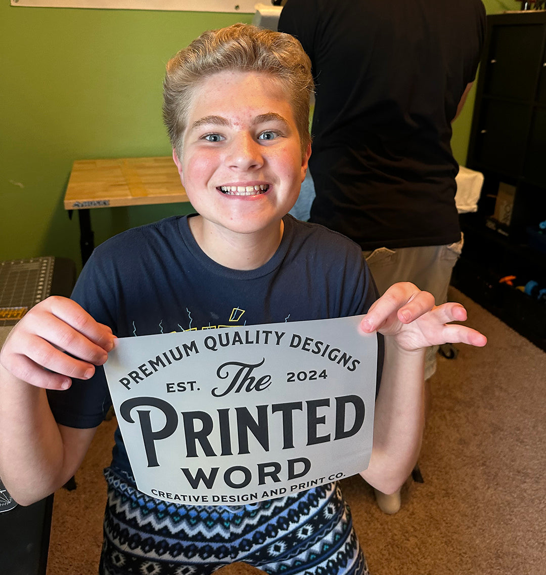 Braden holding the Printed Word sign